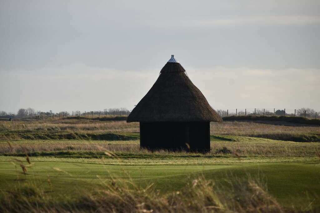 A traditional thatched shelter on the links at Royal St. George's Golf Club, Kent, England